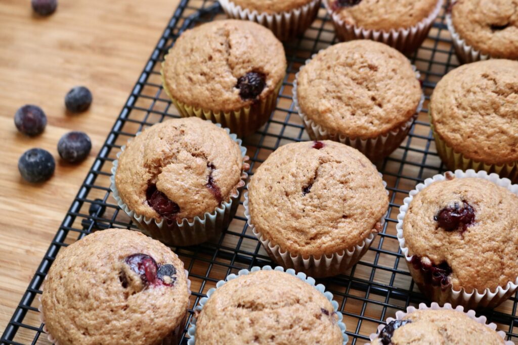 fresh milled blueberry banana muffins on cooling rack angled to the right