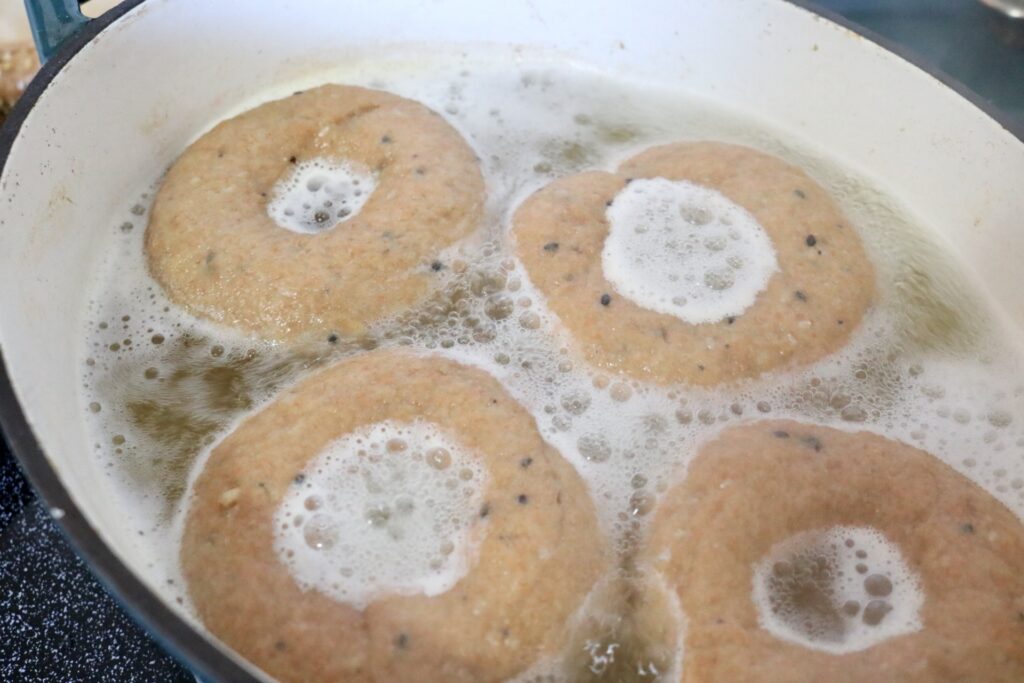 four whole grain everything bagels in boiling water