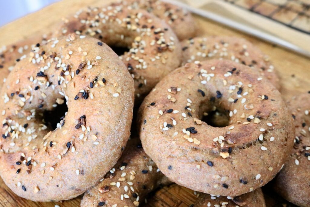 whole grain everything bagels stacked on counter