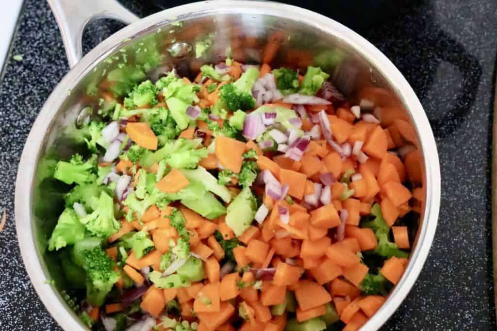 Creamy potato vegetable soup chopped vegetables in pan