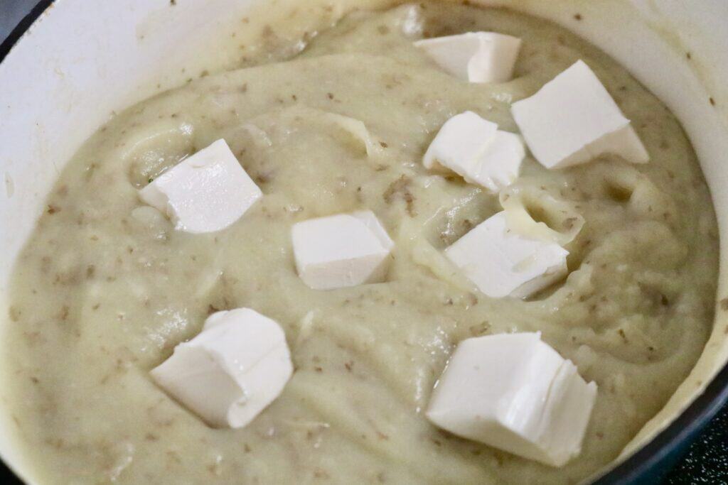 Creamy potato vegetable soup with cream cheese chunks in it