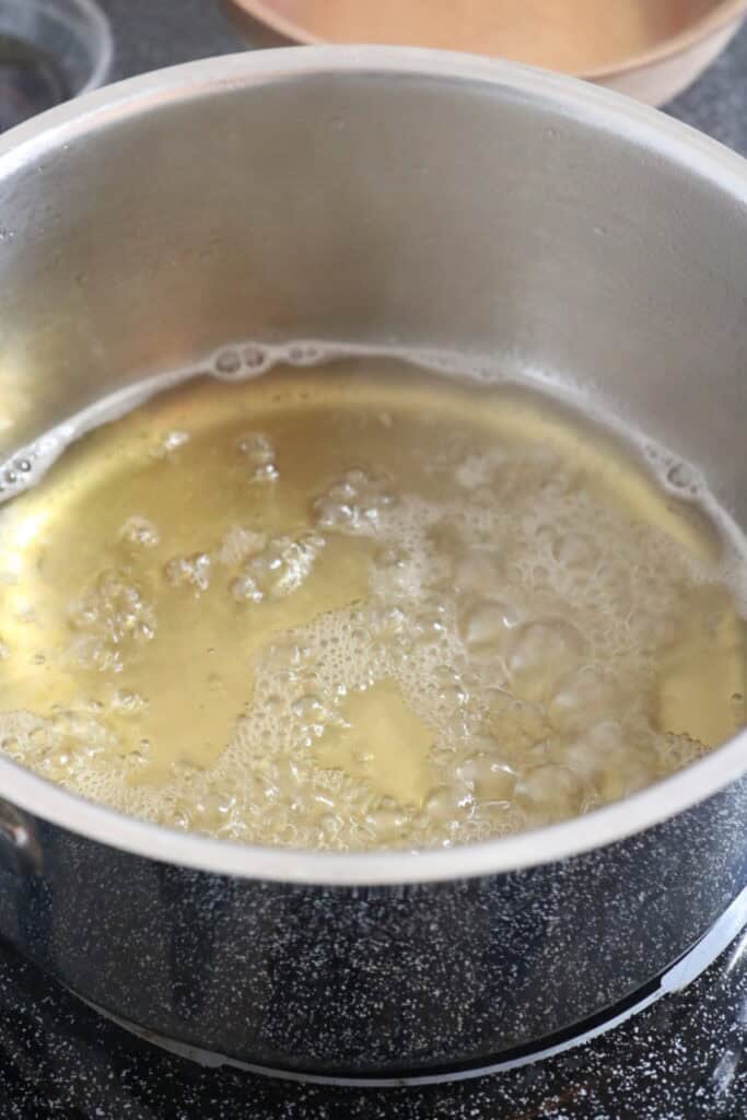 homemade coffee syrup boiling in a saucepan