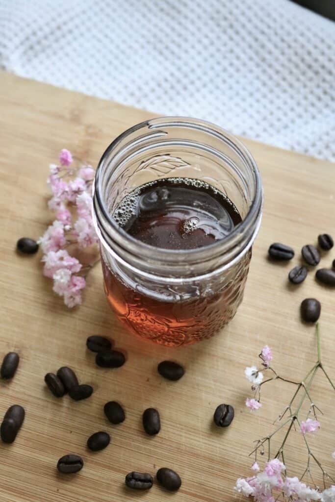 angled view of homemade coffee syrup in a jar