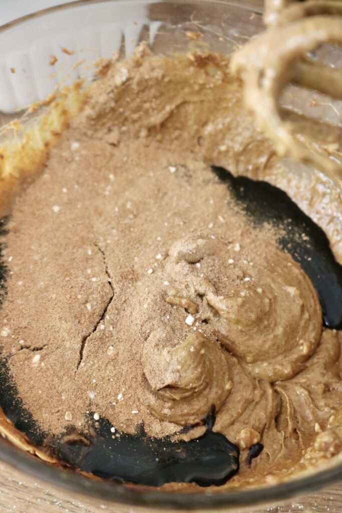 sourdough whole grain molasses cookie batter with molasses and spices on top