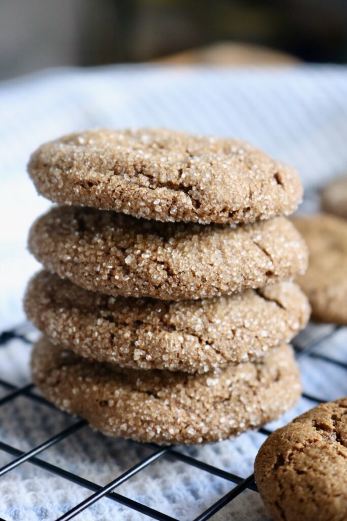 4 sourdough whole grain molasses cookies stacked on cooling rack