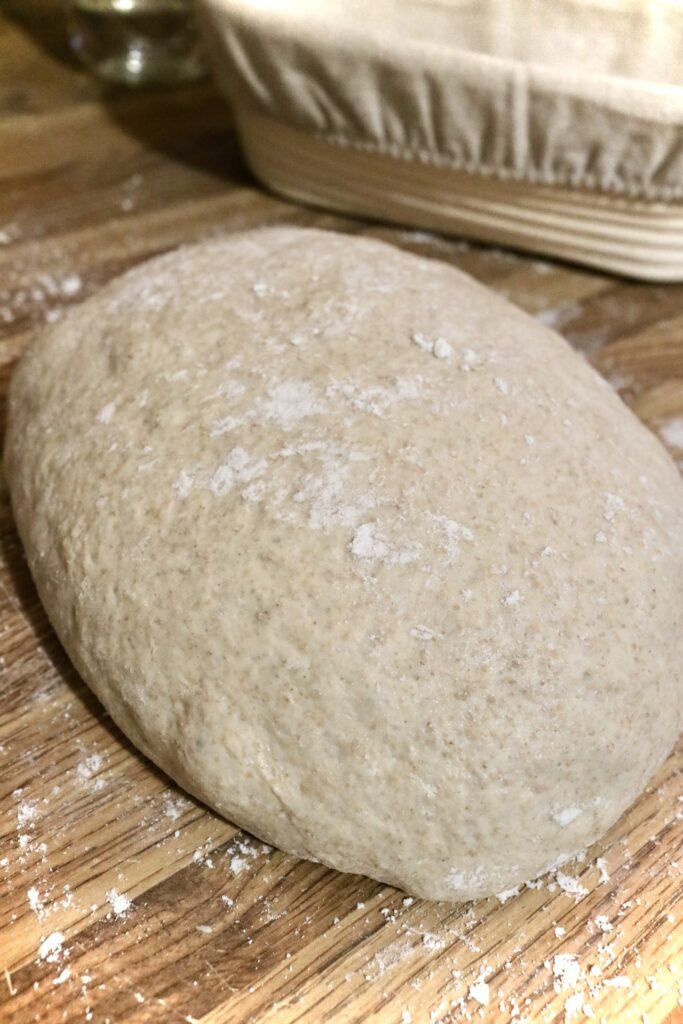 Spelt sourdough bread dough on countertop dusted with flour
