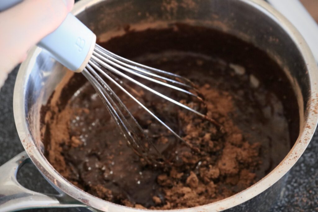whisking mocha sauce in a saucepan on the stovetop