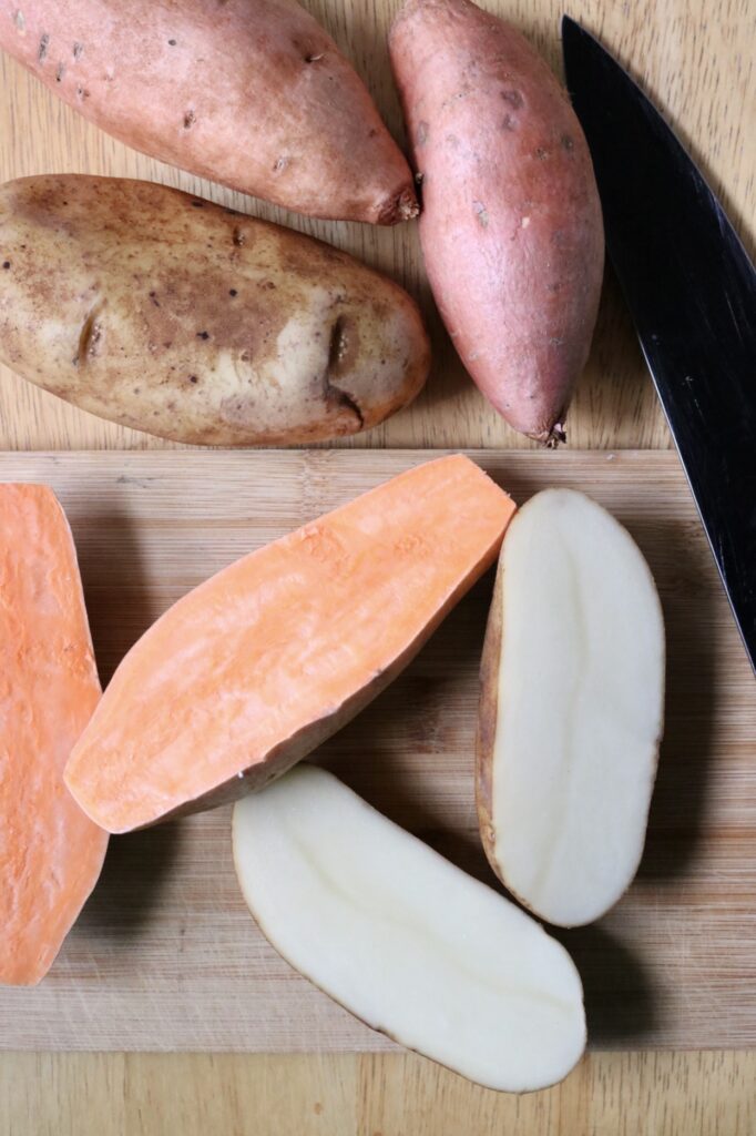 potatoes sliced in half on a cutting board