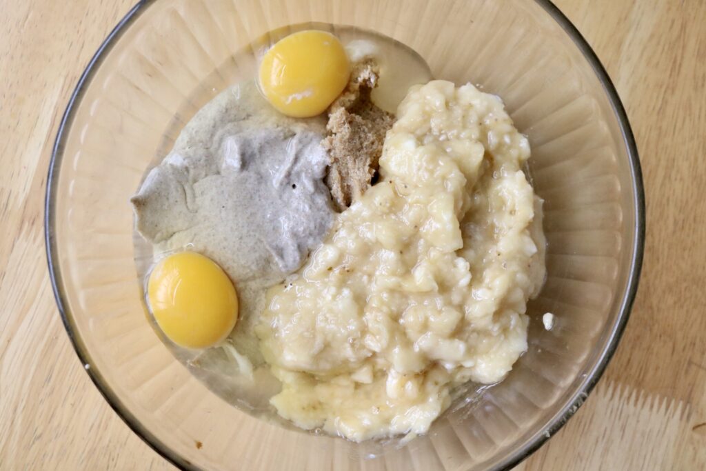 eggs, sourdough discard, and mashed bananas in a glass bowl