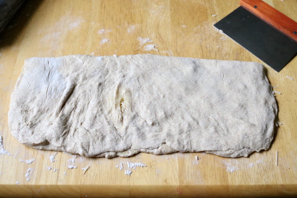rectangle of dough folded over on tabletop